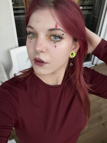 Lera Nyxee artistic portrait with red hair and black top, modern dark feminine style